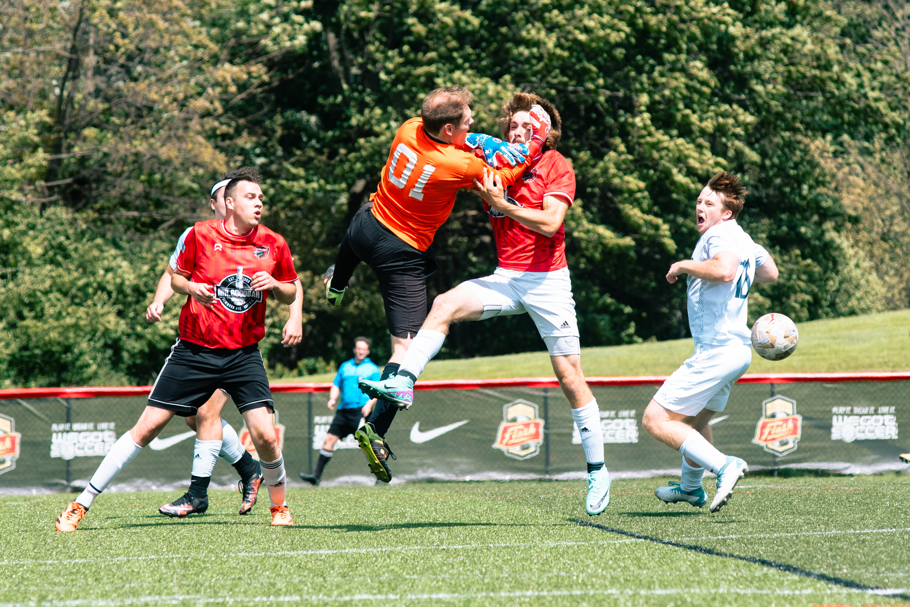 Rust Belt United forward battling for an aerial ball in front of goal