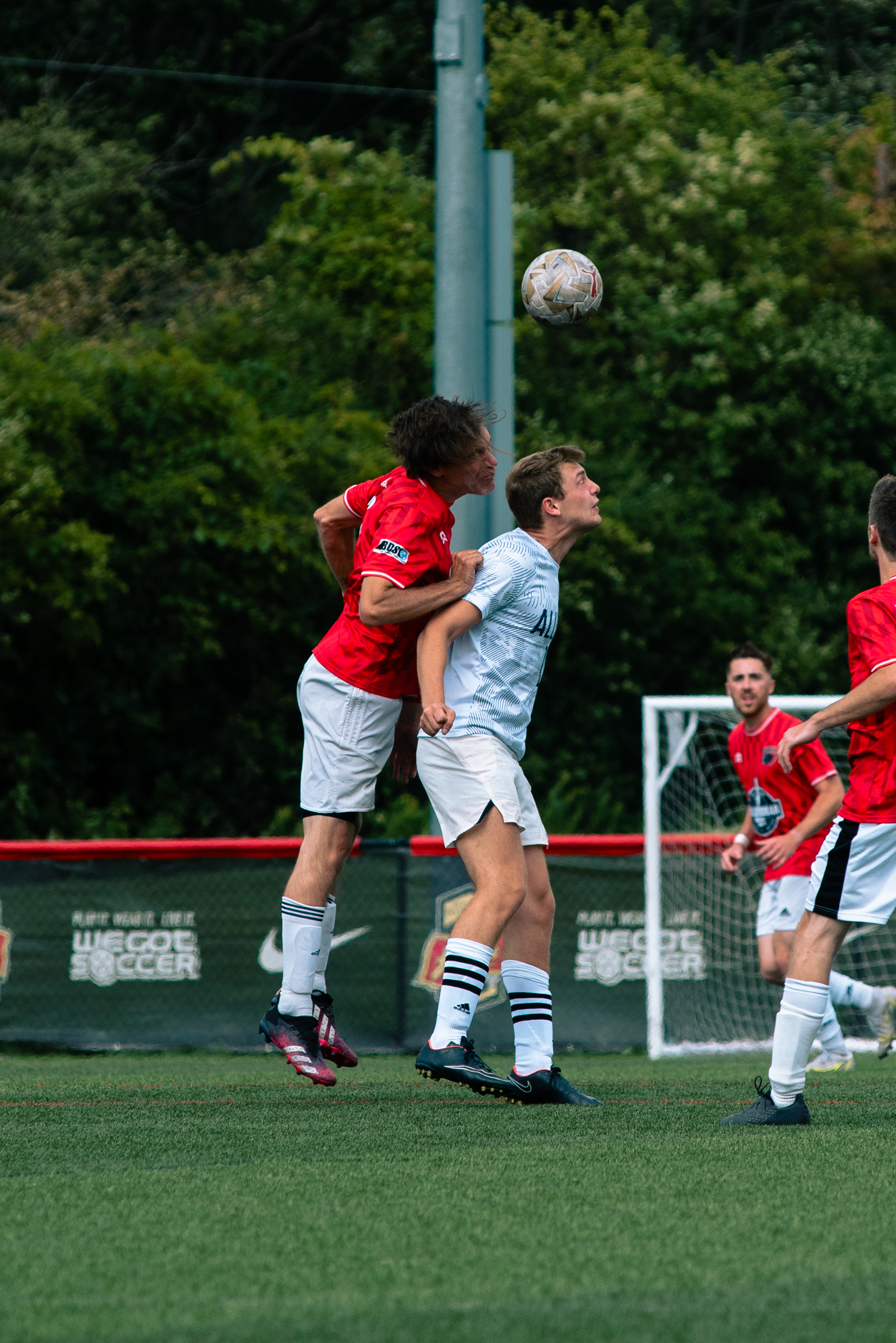 Rust Belt United goalkeeper crashing into a crowded box to punch the ball clear