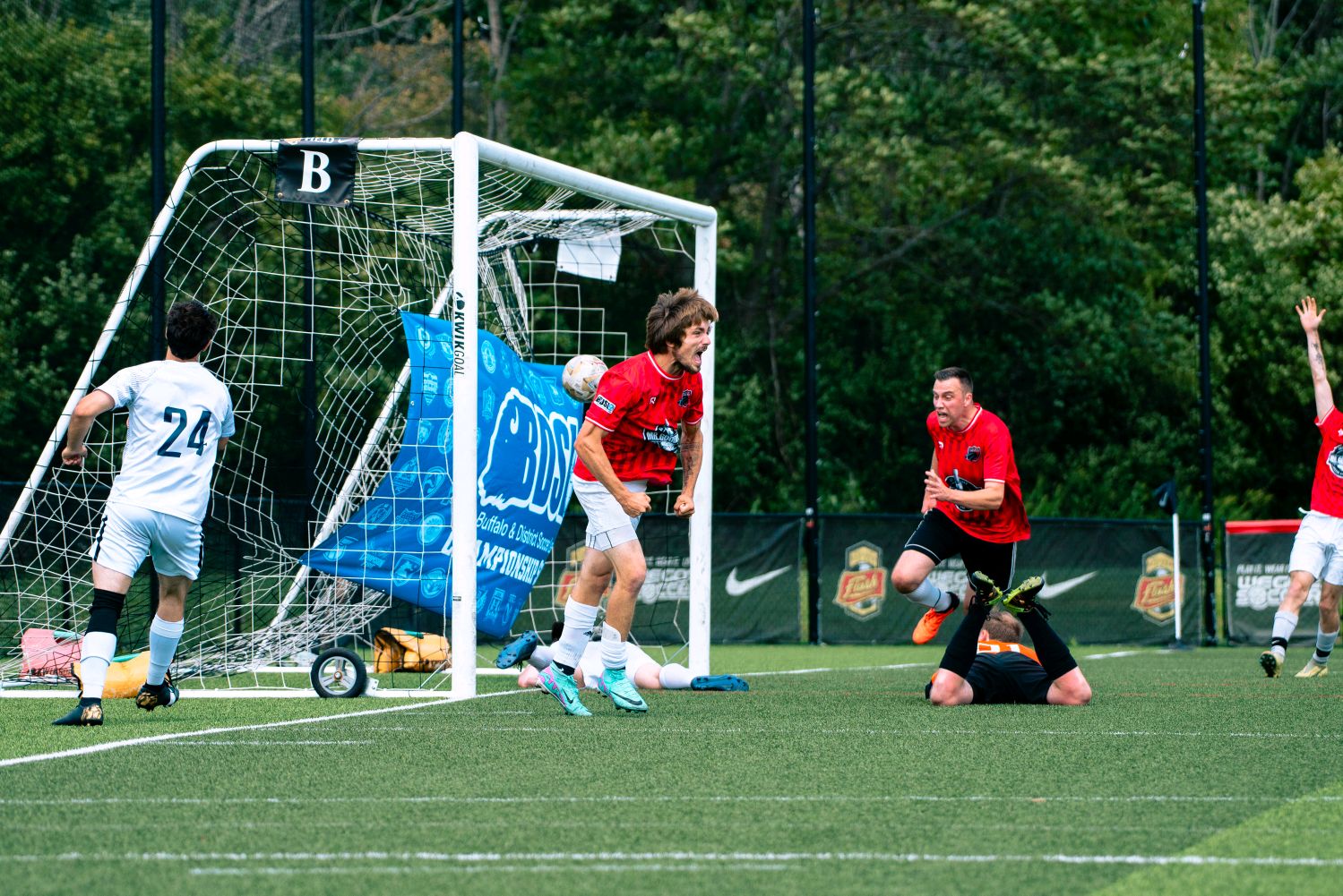Rust Belt United player winning a header in traffic