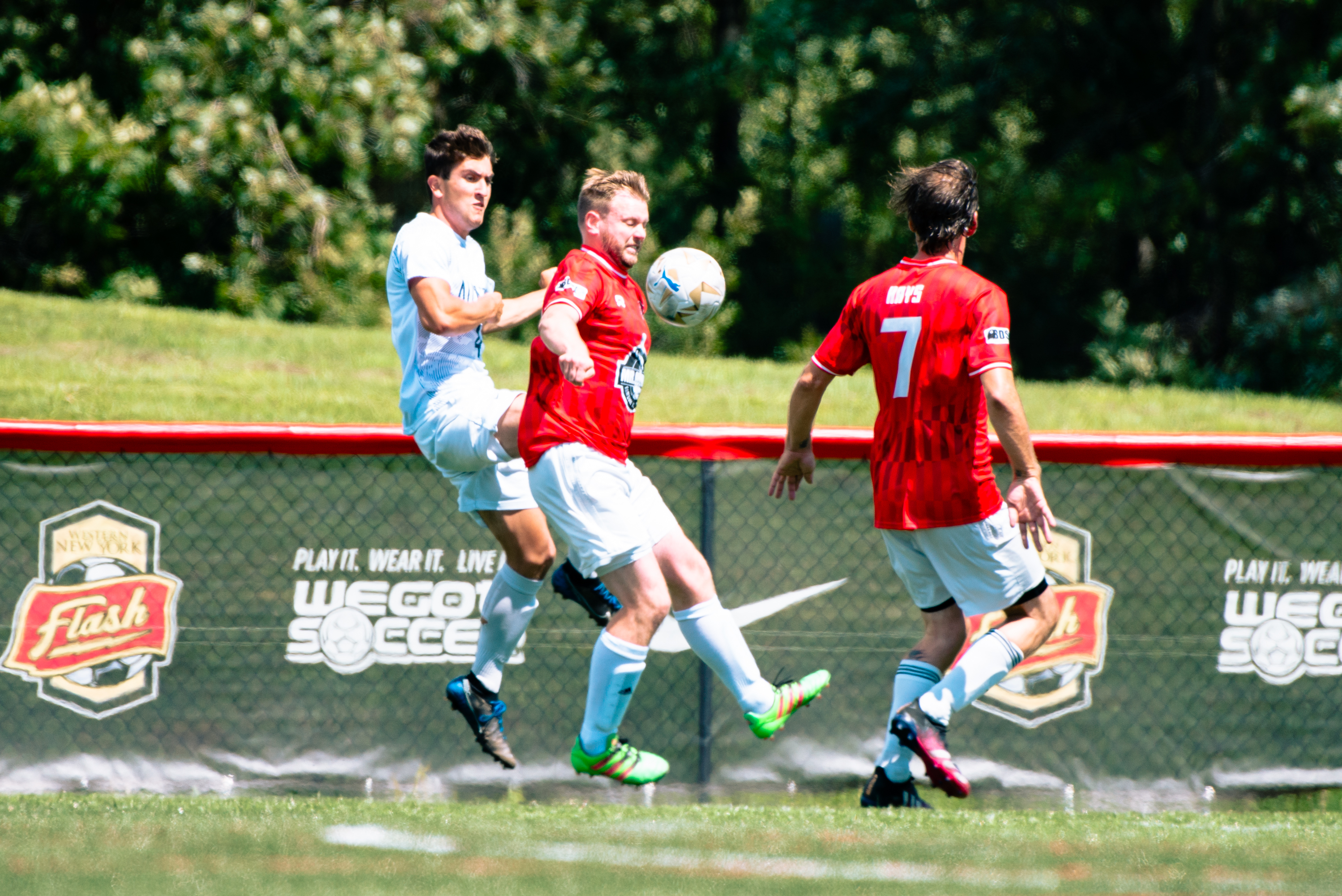 Rust Belt United winger driving forward on the dribble with a defender chasing
